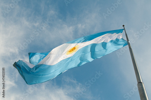 Flag Buenos Aires growing against the blue sky.