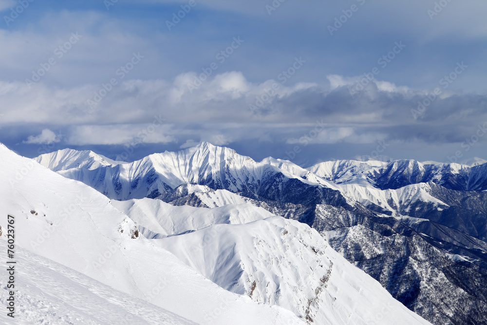 Off-piste slope and snowy mountains