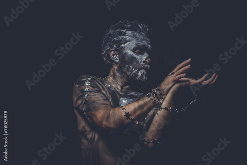 naked wild man with tribal paint