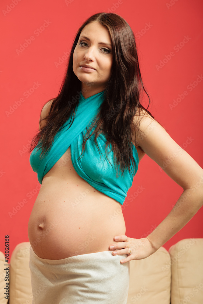 Attractive pregnant woman touching her belly Attractive pregnant woman touching her belly