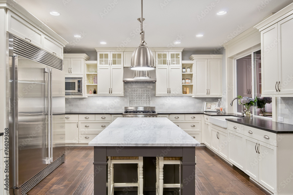 Beautiful Kitchen in Luxury Home with Island and Stainless Steel - obrazy, fototapety, plakaty 