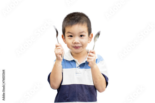 Little handsome Asian boy portrait holding spoon and fork with smiling face isolated on white background