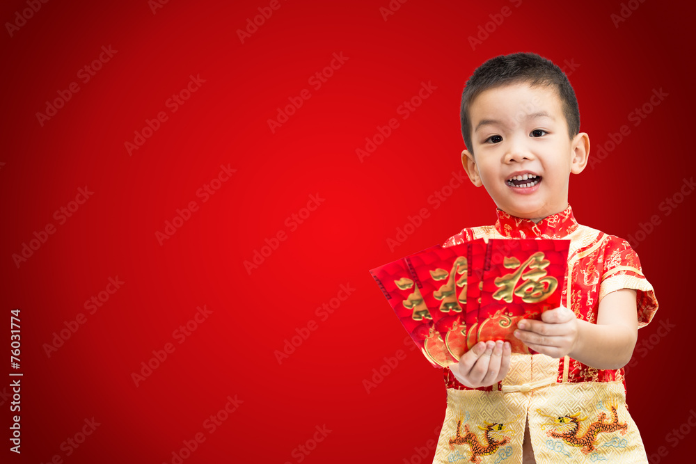 Little Asian boy wearing red traditional Chinese suit and holdin Little Asian boy wearing red traditional Chinese suit and holdin