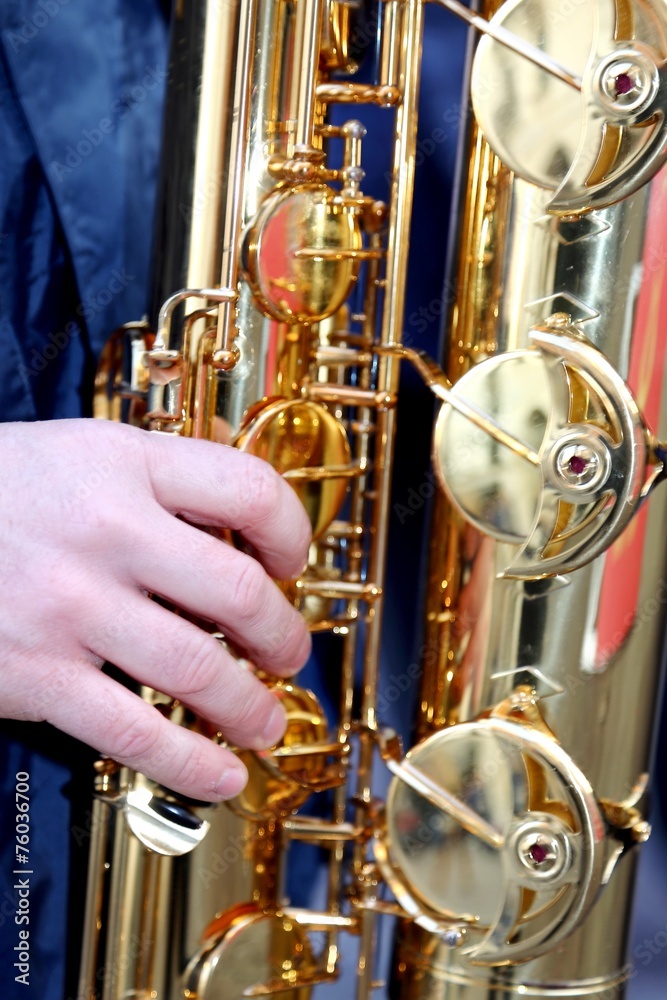 Fototapeta premium Young's hand playing with sounds experienced saxophone