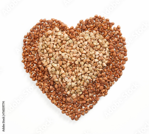 Heart shape made of premium buckwheat groats on white background