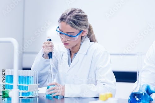 Science student using pipette in the lab