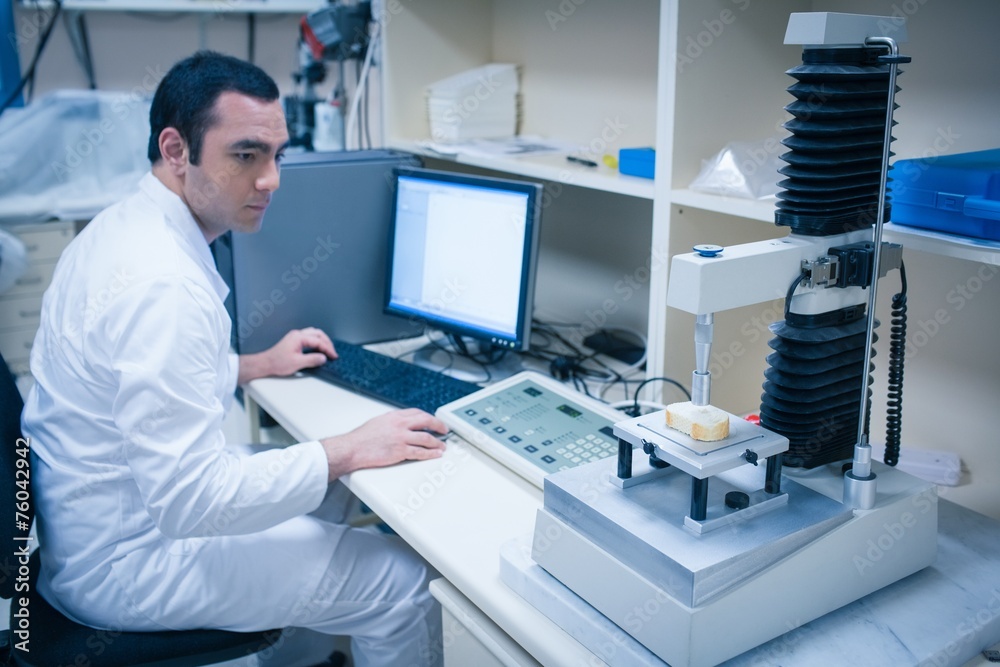 Food scientist using technology to analyse bread Food scientist using technology to analyse bread