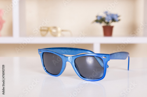 Blue sunglasses on table