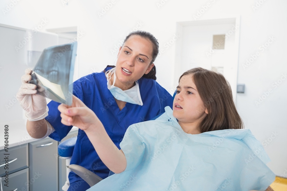 Pediatric dentist explaining to young patient the x-ray Pediatric dentist explaining to young patient the x-ray