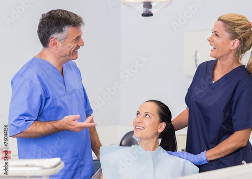 Fototapeta Naklejka Na Ścianę i Meble -  Smiling dentist and nurse speaking with their patient