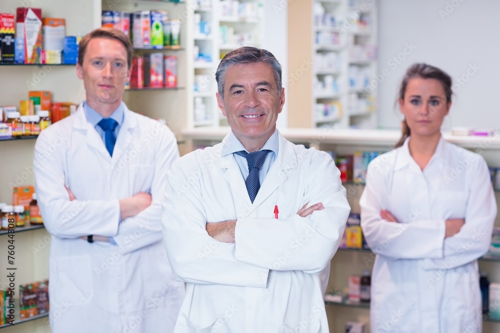 Smiling pharmacy team standing with arms folded Smiling pharmacy team standing with arms folded