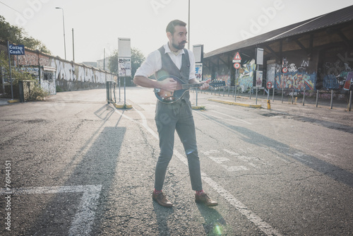 handsome big moustache hipster man playing mandolin