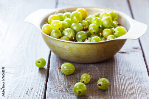 Green gooseberries in a aluminum bowl