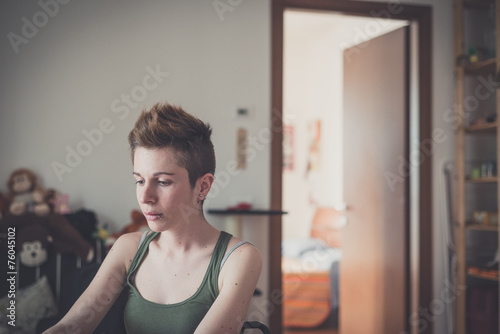Fototapeta Naklejka Na Ścianę i Meble -  young lesbian stylish hair style woman using notebook