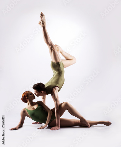 Couple of gymnasts on a light grey background