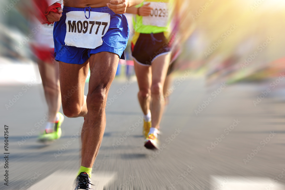 marathon athletes legs running on city road