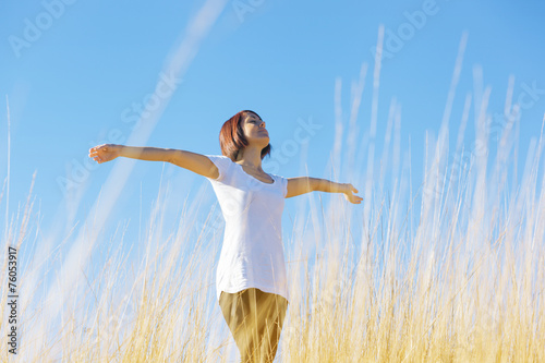 happy girl in field of tall grass golden