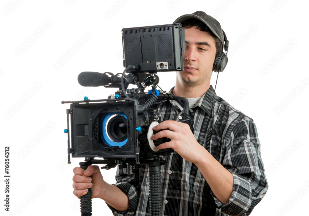 young cameraman with professionnal movie camera