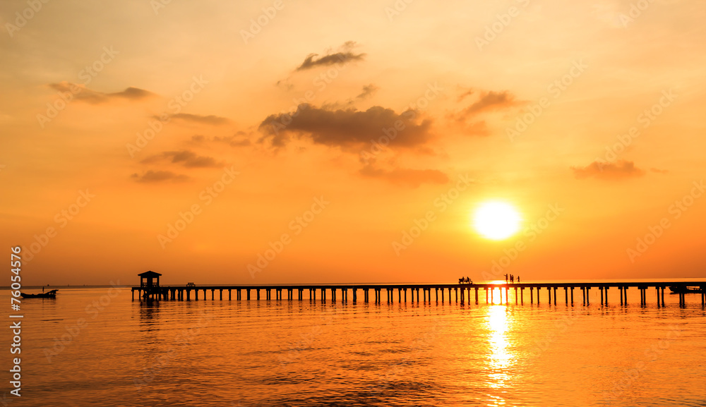 silhouette people on wood bridge with sunset