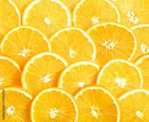 Background of heap fresh yellow lemon slices.