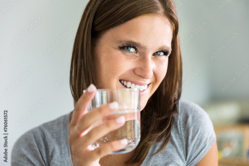 Portraiture of young smiling woman with glass of water Portraiture of young smiling woman with glass of water