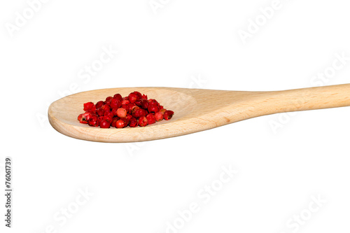 Red pepper on a light wooden spoon
