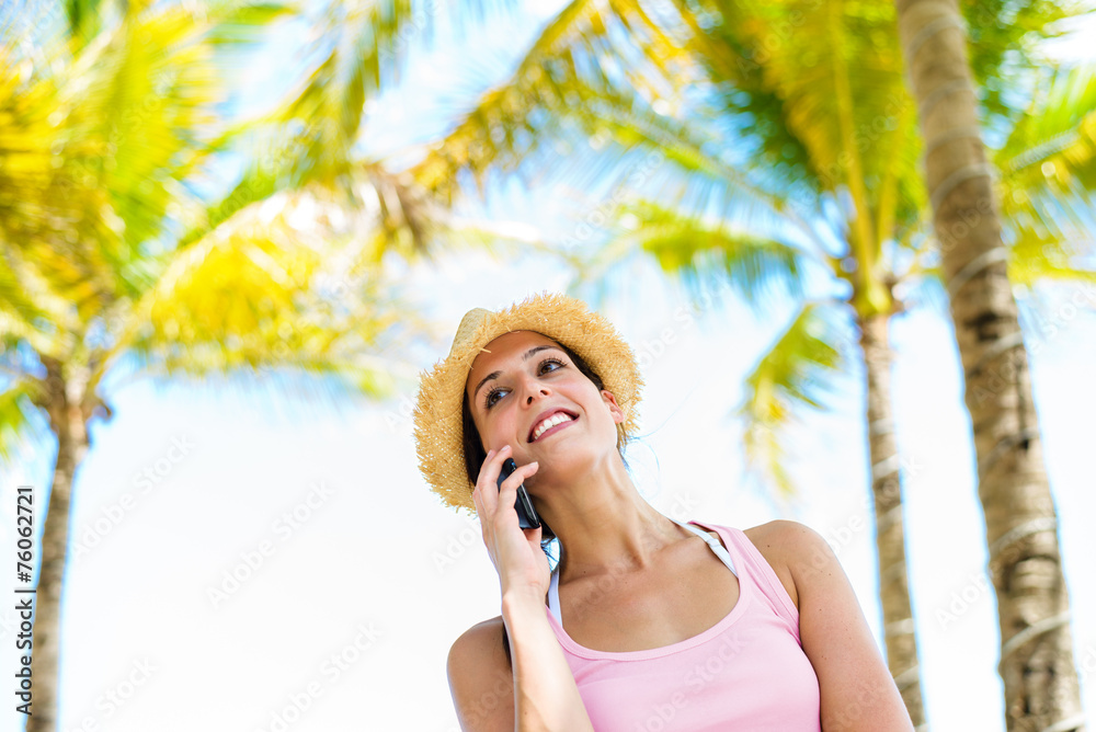 Woman on summer tropical vacation smartphone call
