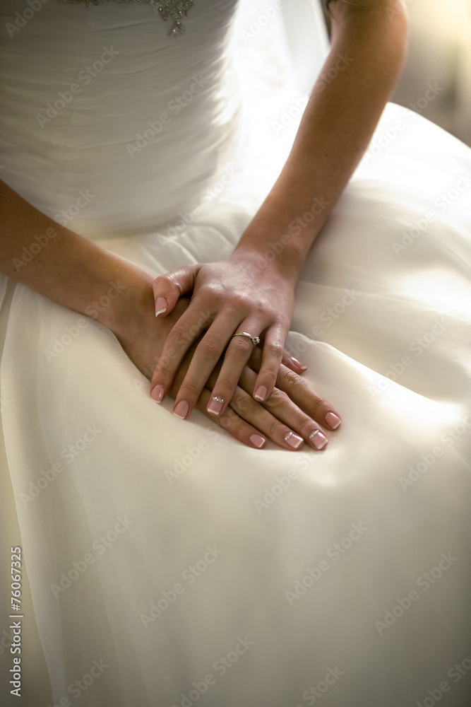 portrait of brides hands lying on white wedding dress portrait of brides hands lying on white wedding dress