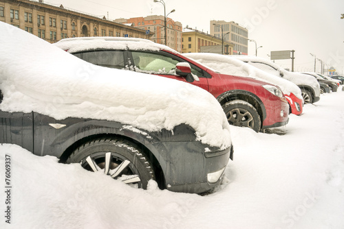 Snow covered cars in the street