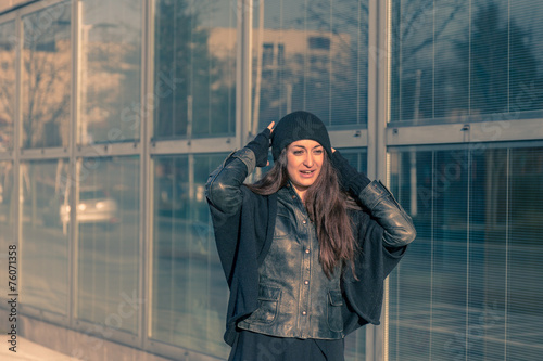 Beautiful young woman posing in the city streets