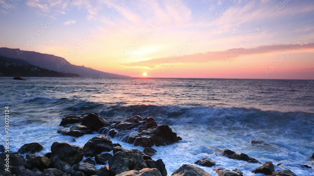 Waves break about stones at sunrise over the sea Waves break about stones at sunrise over the sea
