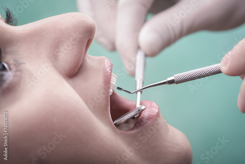 Young woman and dental instrument