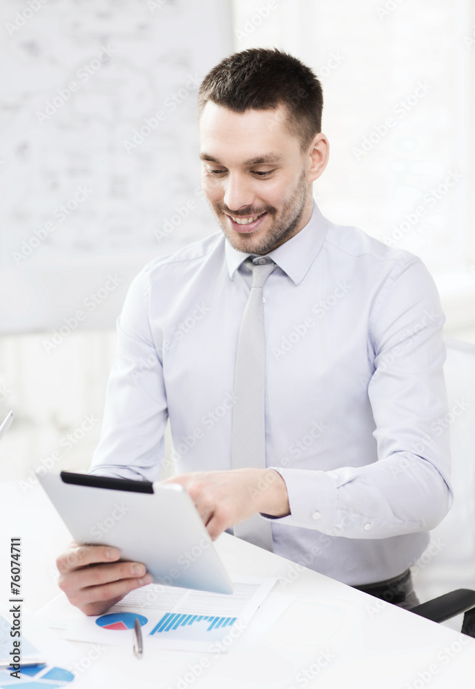 businessman with tablet pc and files in office businessman with tablet pc and files in office