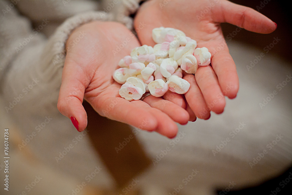 Hands holding mug of hot chocolate with marshmallows close-up Hands holding mug of hot chocolate with marshmallows close-up