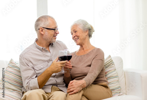 happy senior couple with glasses of red wine
