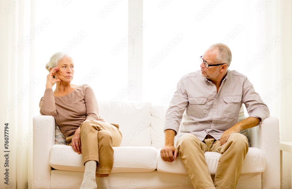 senior couple sitting on sofa at home senior couple sitting on sofa at home