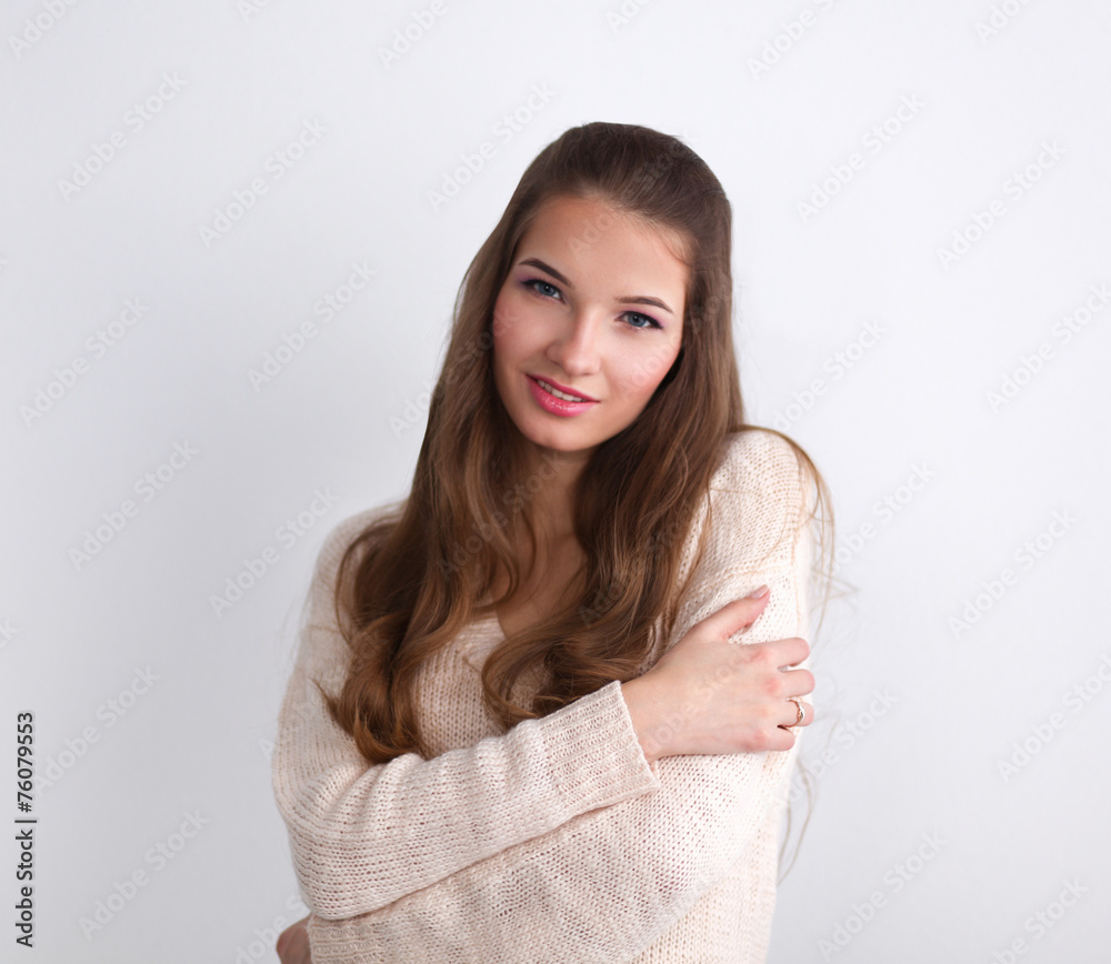 Young woman standing, isolated on gray background Young woman standing, isolated on gray background