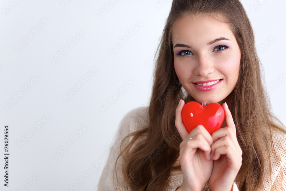 Portrait of beautiful happy woman holding a symbol heart. Portrait of beautiful happy woman holding a symbol heart.
