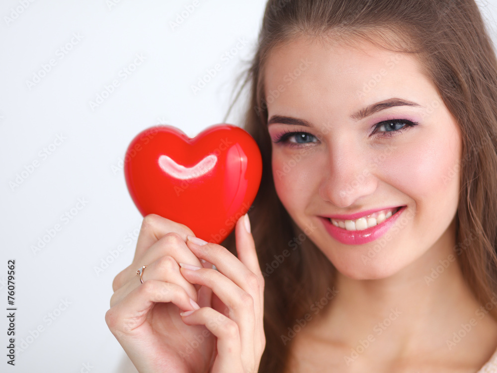 Portrait of beautiful happy woman holding a symbol heart. Portrait of beautiful happy woman holding a symbol heart.