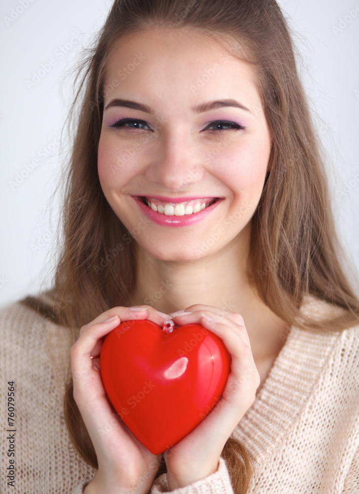 Portrait of beautiful happy woman holding a symbol heart. Portrait of beautiful happy woman holding a symbol heart.