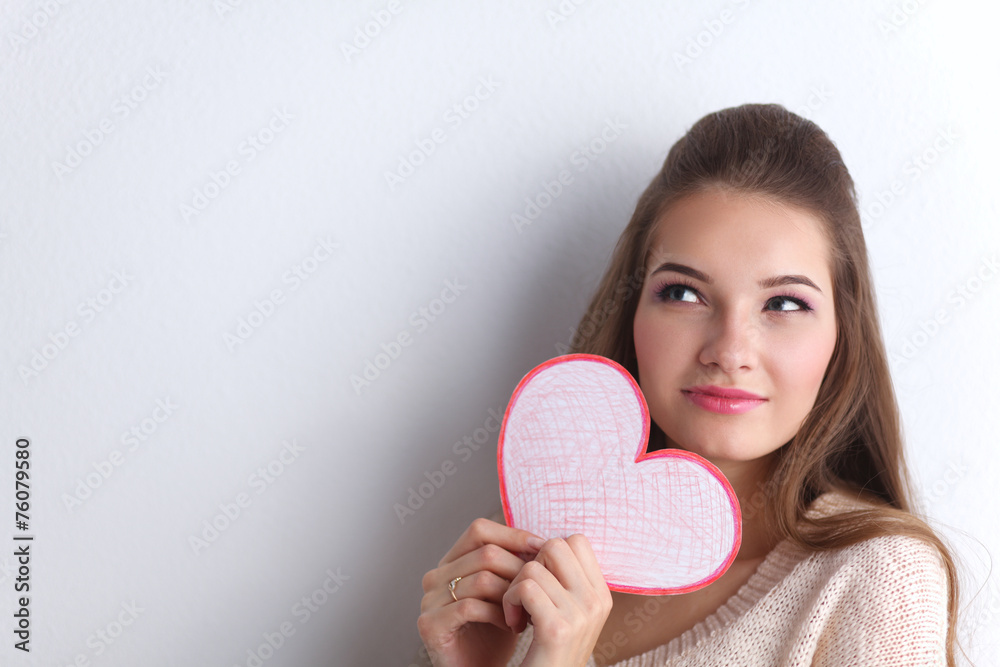 Portrait of beautiful happy woman holding a symbol heart. Portrait of beautiful happy woman holding a symbol heart.
