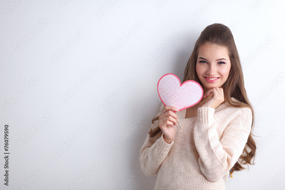 Portrait of beautiful happy woman holding a symbol heart. Portrait of beautiful happy woman holding a symbol heart.