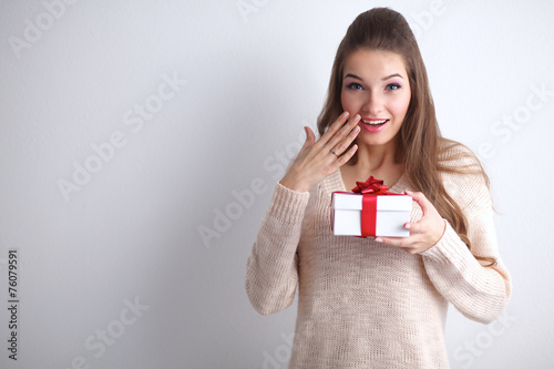 Young woman happy smile hold gift box in hands,standing over