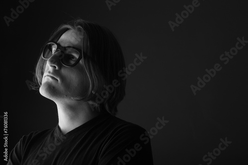 Thoughtful man in eyeglasses portrait, monochrome