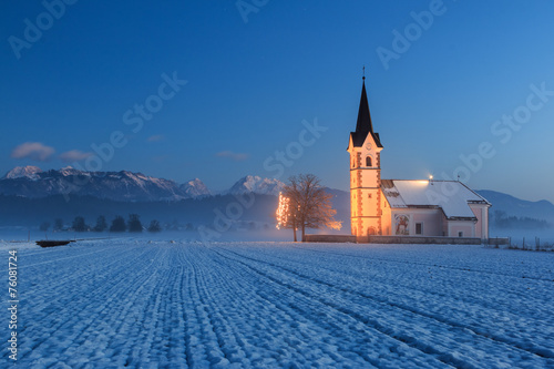 St. Florian church with a view to the alps at dawn