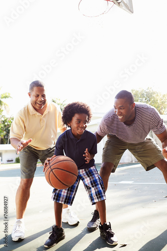 Grandfather With Son And Grandson Playing Basketball © Monkey Business