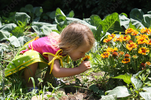 Small cute kid walk in garden