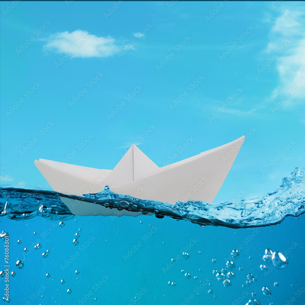 Obraz premium paper boat floating among the waves in the ocean
