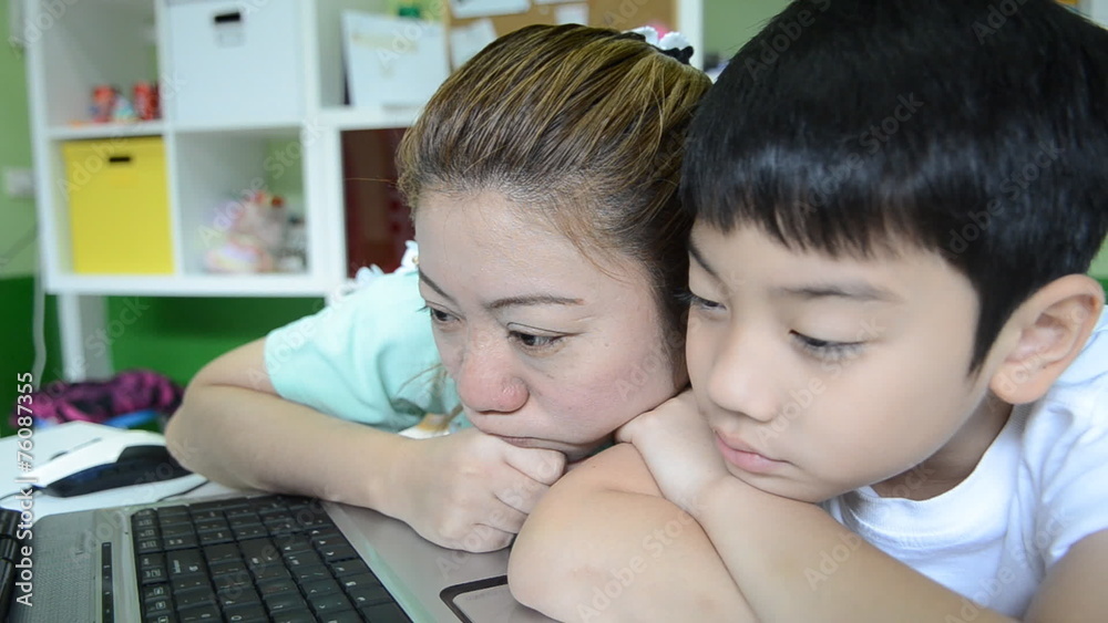 Asian lazy family Using Laptop in living room Asian lazy family Using Laptop in living room