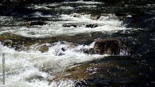 Pure running water of a river in the wilderness photo